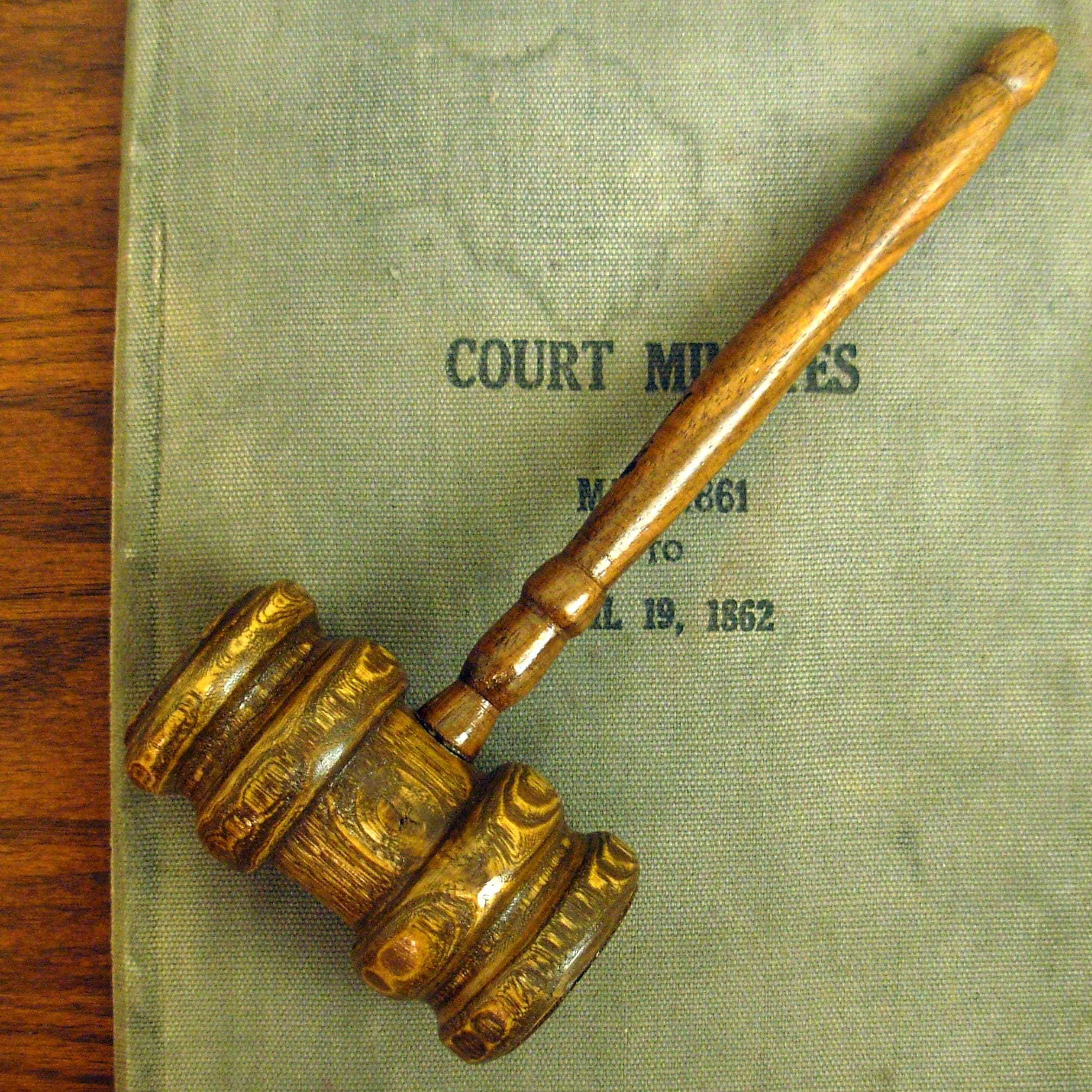 BIRTH OF A NEW JURISPRUDENCE Judge's gavel on a wooden background, signifying courtroom proceedings and justice