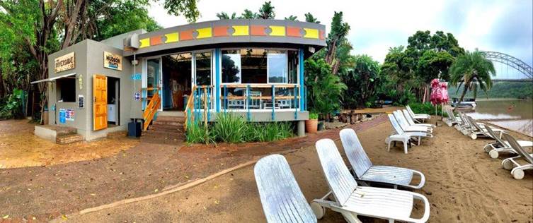 The Riverside Aqua Sports Beach Bar
The Riverside Aqua Sports Beach Bar is the hub for all the resort’s riverside activities, but also provides water sport enthusiasts with a vibey place to relax with a view. The hip bartenders handcraft classic cocktails, and the mouth-watering, savoury menu is simple but will sate your appetite built up over the course of the day – tuck into burgers, boerewors rolls, hot dogs, and bacon and eggs rolls. They also offer a ‘bring and braai’ facility for families and friends to chill alongside the riverbed.
During peak season, the bar is open Sunday to Friday between 09h00 and 18h00 and Saturdays, 09h00 and 20h00.
The braai facility is for guest convenience with a surcharge fee per stand or group. No outside cold drinks or alcohol are permitted as they are a fully licensed establishment.