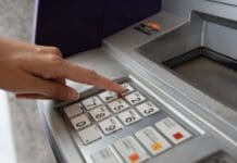 How to Update Your SASSA Banking Details to Avoid Payment Delays Hand pressing one on ATM.width 800