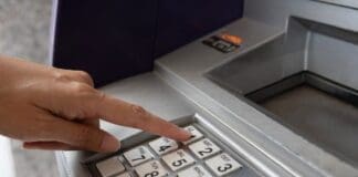 How to Update Your SASSA Banking Details to Avoid Payment Delays Hand pressing one on ATM.width 800